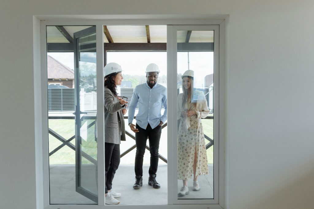 Home buyer celebrating by a new house