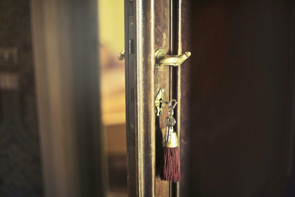 Vintage door with key in lock, symbolizing home ownership.