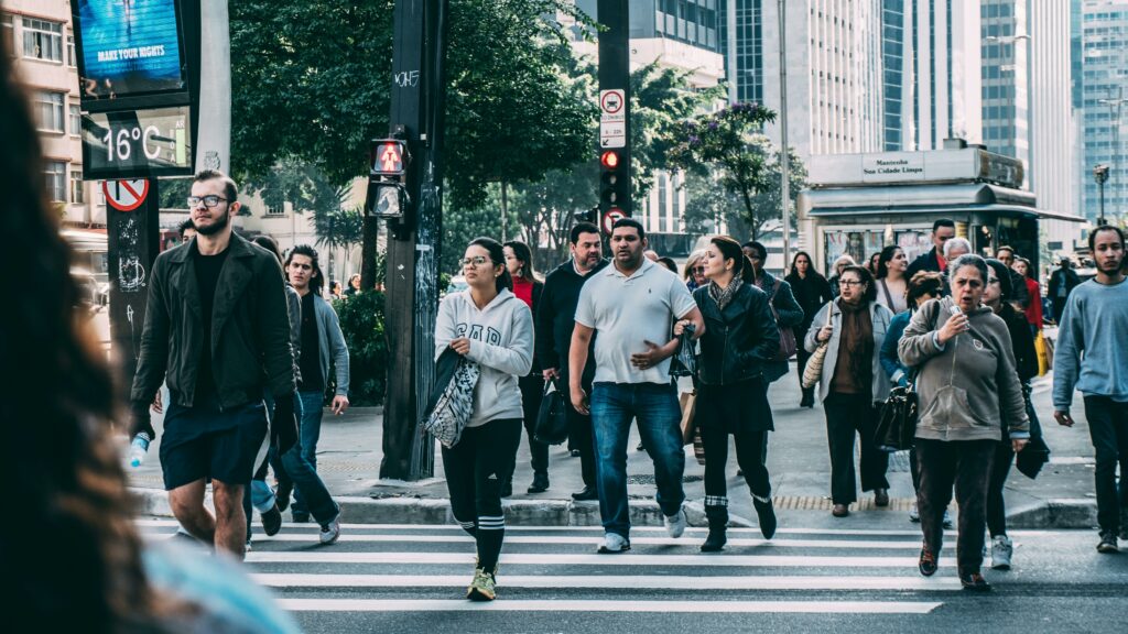 Busy city street crossing filled with pedestrians.