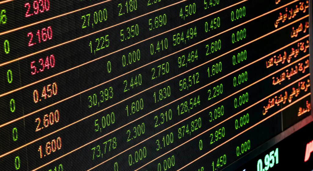 A close-up of a stock exchange LED display showing various financial figures.